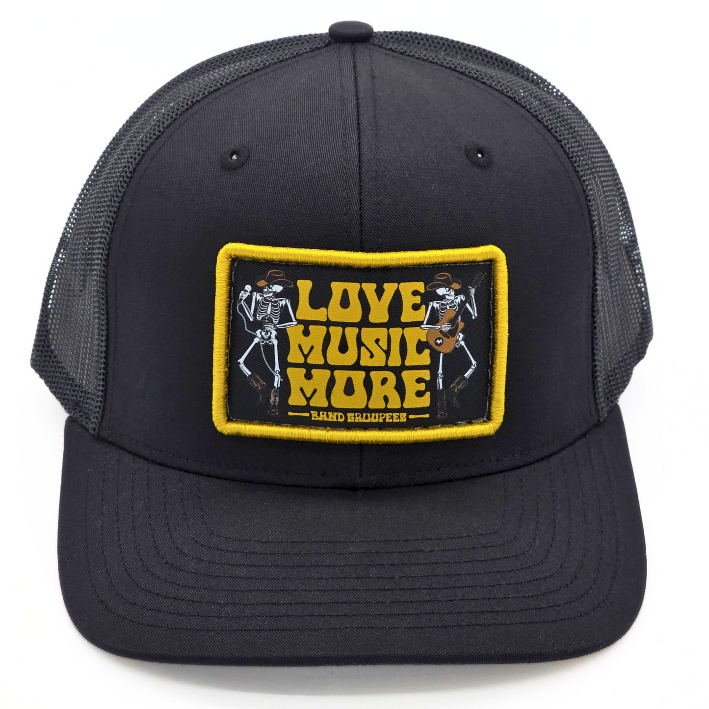 Black trucker cap with a yellow and black patch featuring skeletons playing music and 'Love Music More' text.