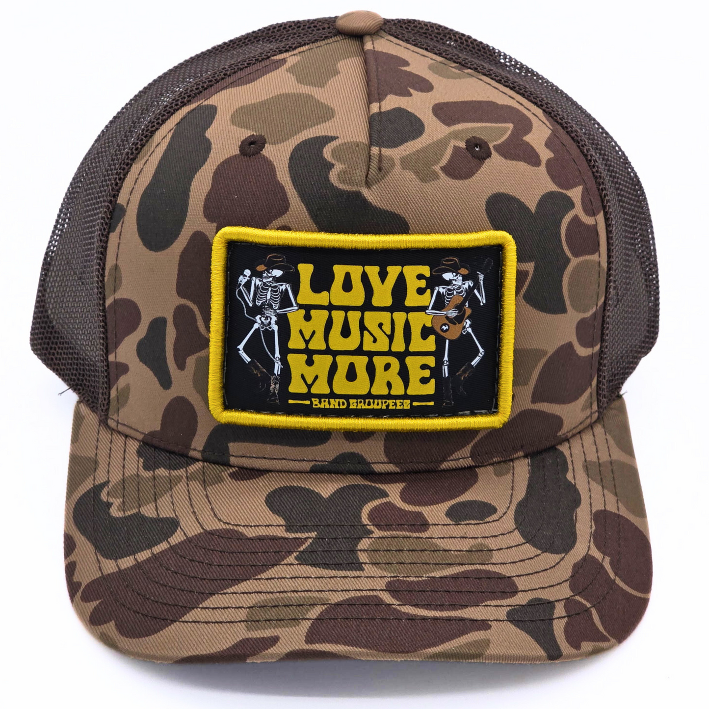Camouflage cap with 'Love Music More' patch on a white background