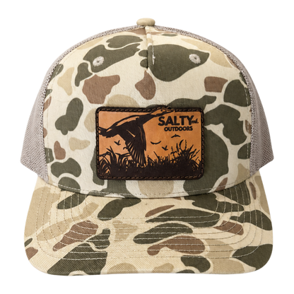 SALTYmf Leather Duck Hunt Patch Trucker in Harvest Duck Camo, front view with the laser-etched leather duck patch
