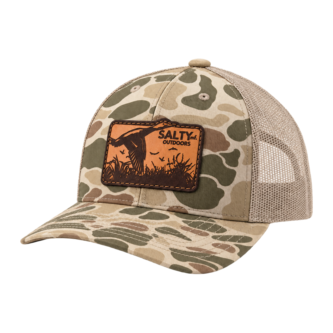 SALTYmf Leather Duck Hunt Patch Trucker in Harvest Duck Camo, three quarter view with the laser-etched leather duck patch