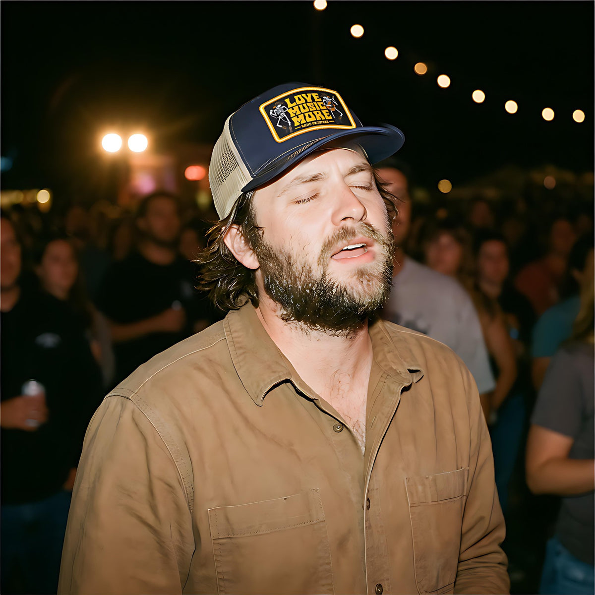 Man in the SALTYmf Love Music More Patch Hat singing along at a live show